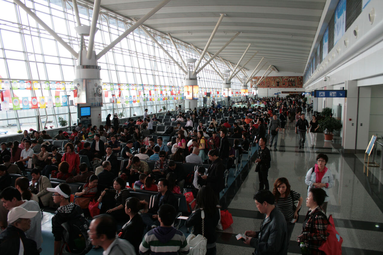 Airport departure hall queue passengers morning