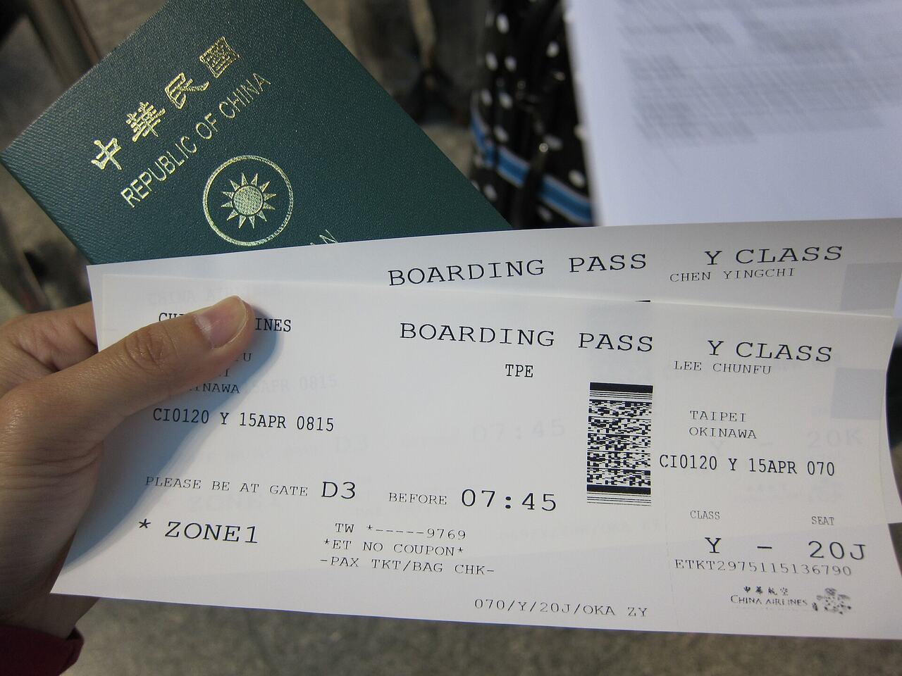Passport and boarding pass on table