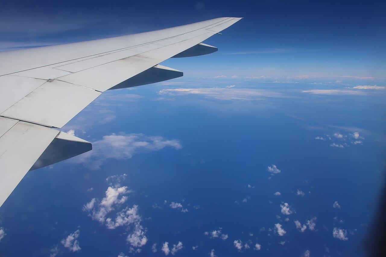 Airplane window view ocean clouds
