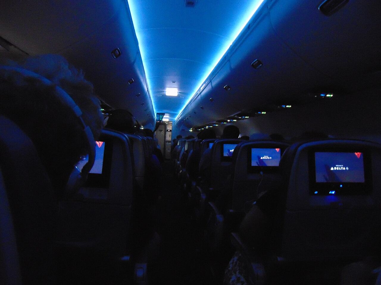 Airplane cabin dark night passengers sleeping
