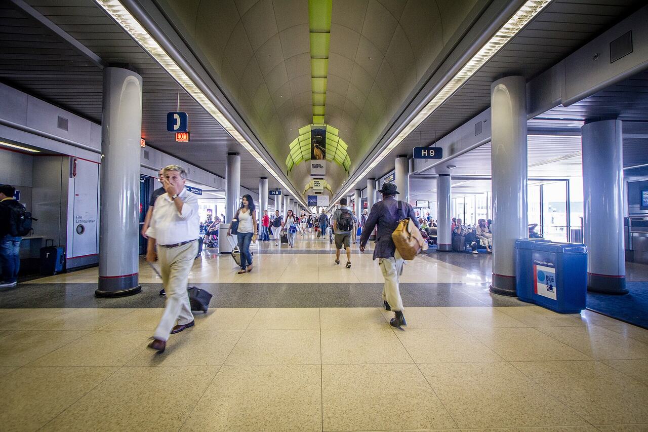 Passengers running airport corridor hurry